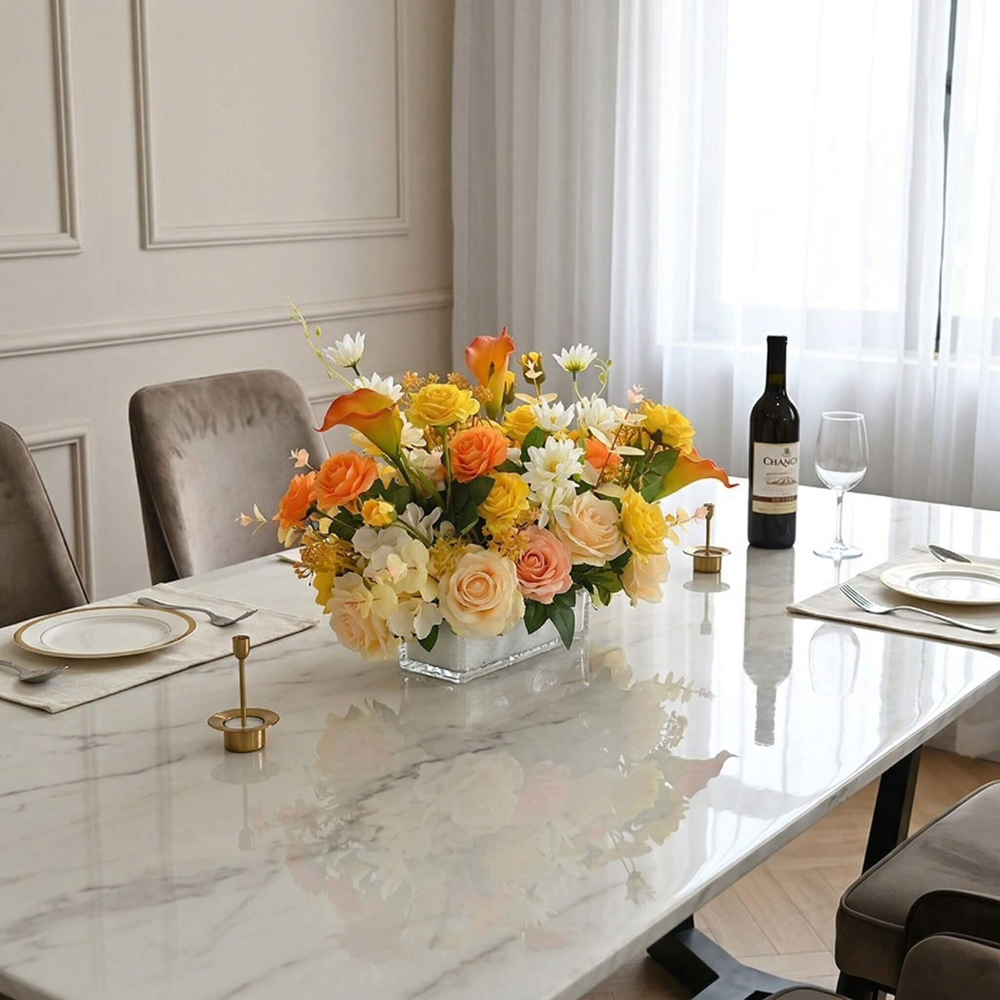 Faux calla lily and rose flower centerpiece with eucalyptus decorating a dining table