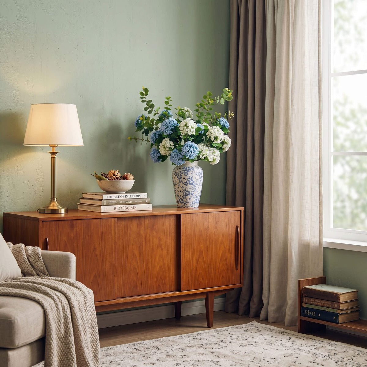 Faux hydrangea arrangement styled in a living room, adding a fresh and elegant touch to console table decor.