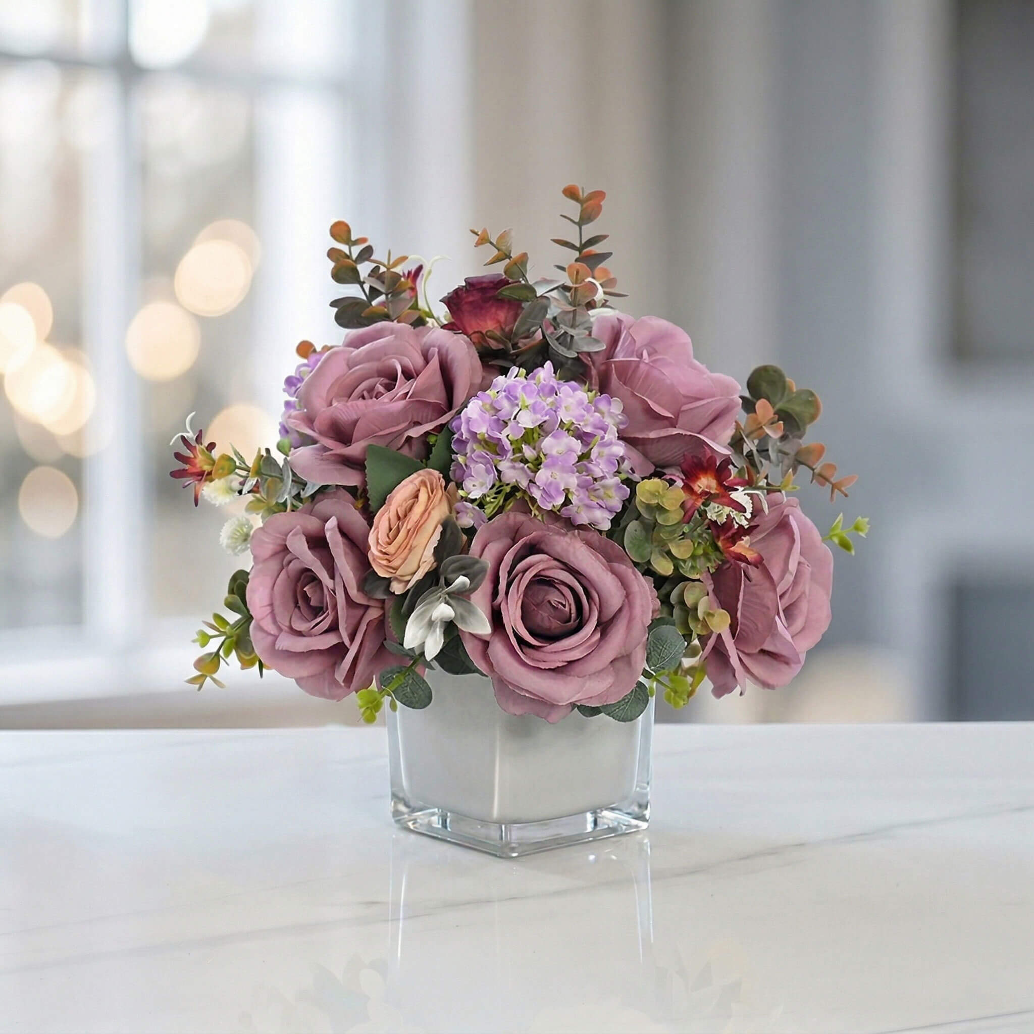 Purple artificial rose and hydrangea floral arrangement with eucalyptus