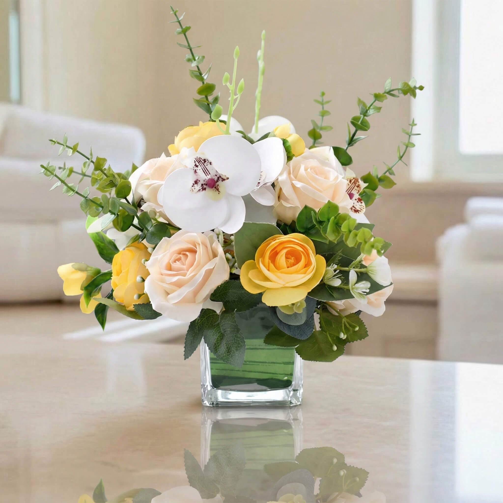 Champagne artificial orchid and rose floral arrangement with eucalyptus for elegant home decoration