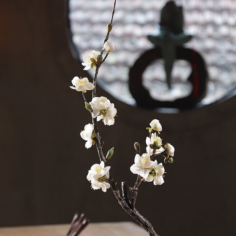 White artificial plum blossom in a front view, showcasing a clean look and subtle petal texture.