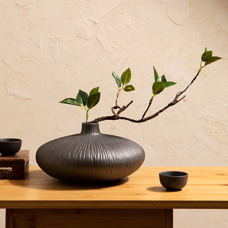 Faux ficus plant in black ceramic vase designed for modern minimalist home decor