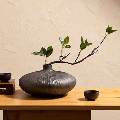 Faux ficus plant in black ceramic vase designed for modern minimalist home decor