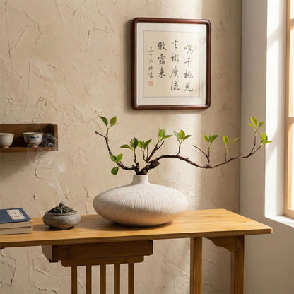 Faux ficus plant in white ceramic vase creating a peaceful zen meditation space