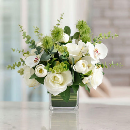 White artificial orchid and rose flower centerpiece with eucalyptus