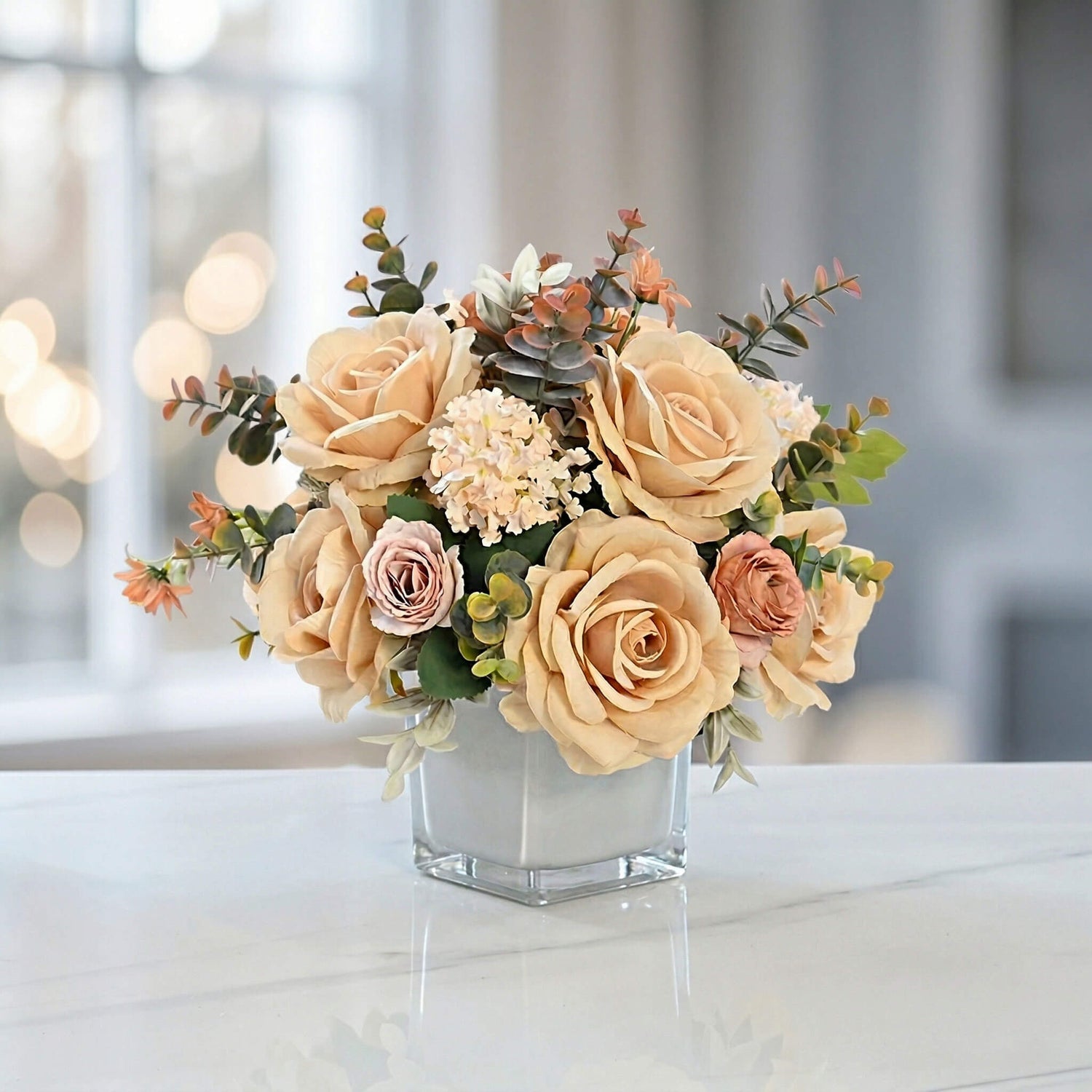 Champagne artificial rose and hydrangea floral centerpiece with eucalyptus