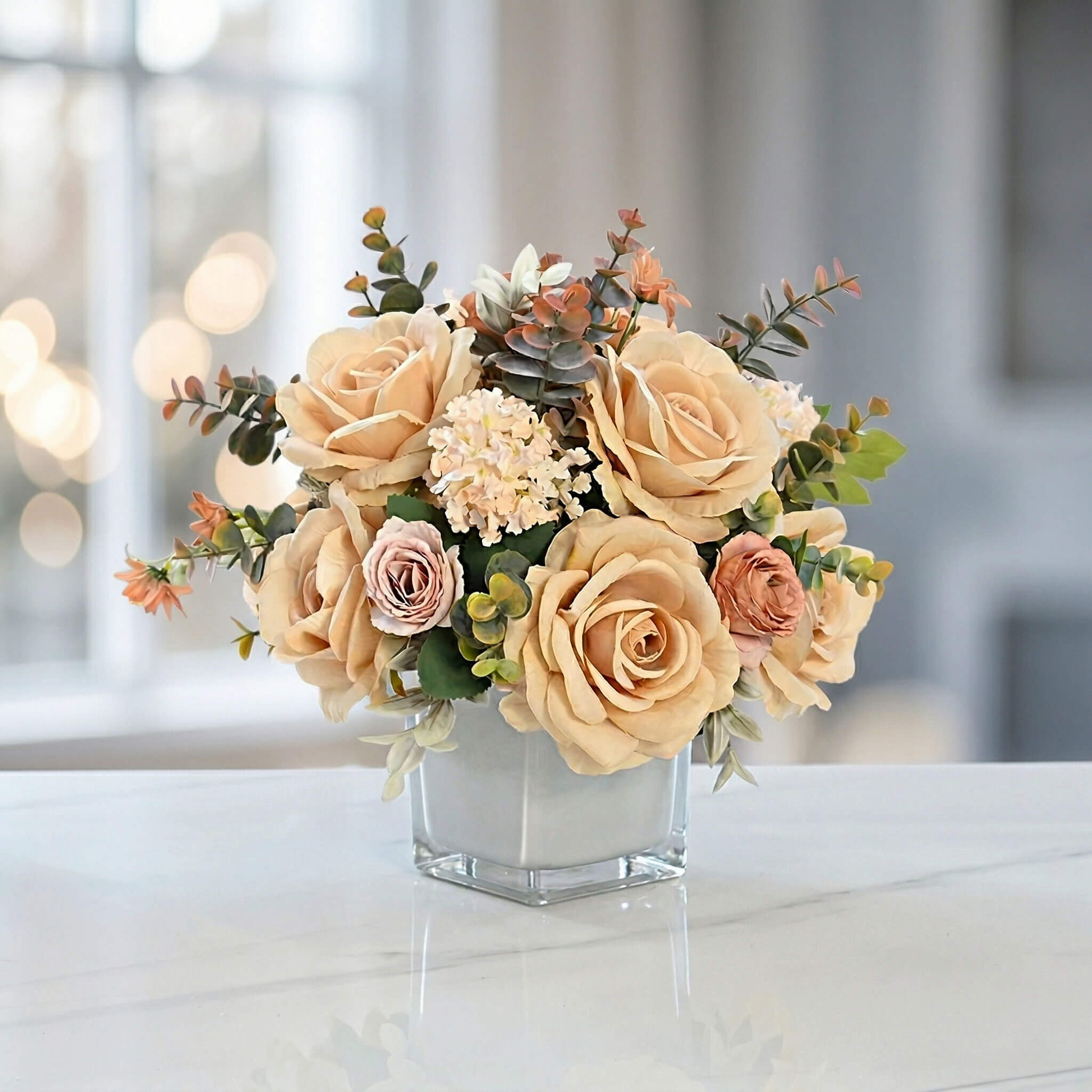 Champagne artificial rose and hydrangea floral centerpiece with eucalyptus