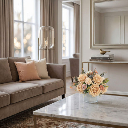 Champagne artificial rose and hydrangea flower centerpiece on a living room coffee table