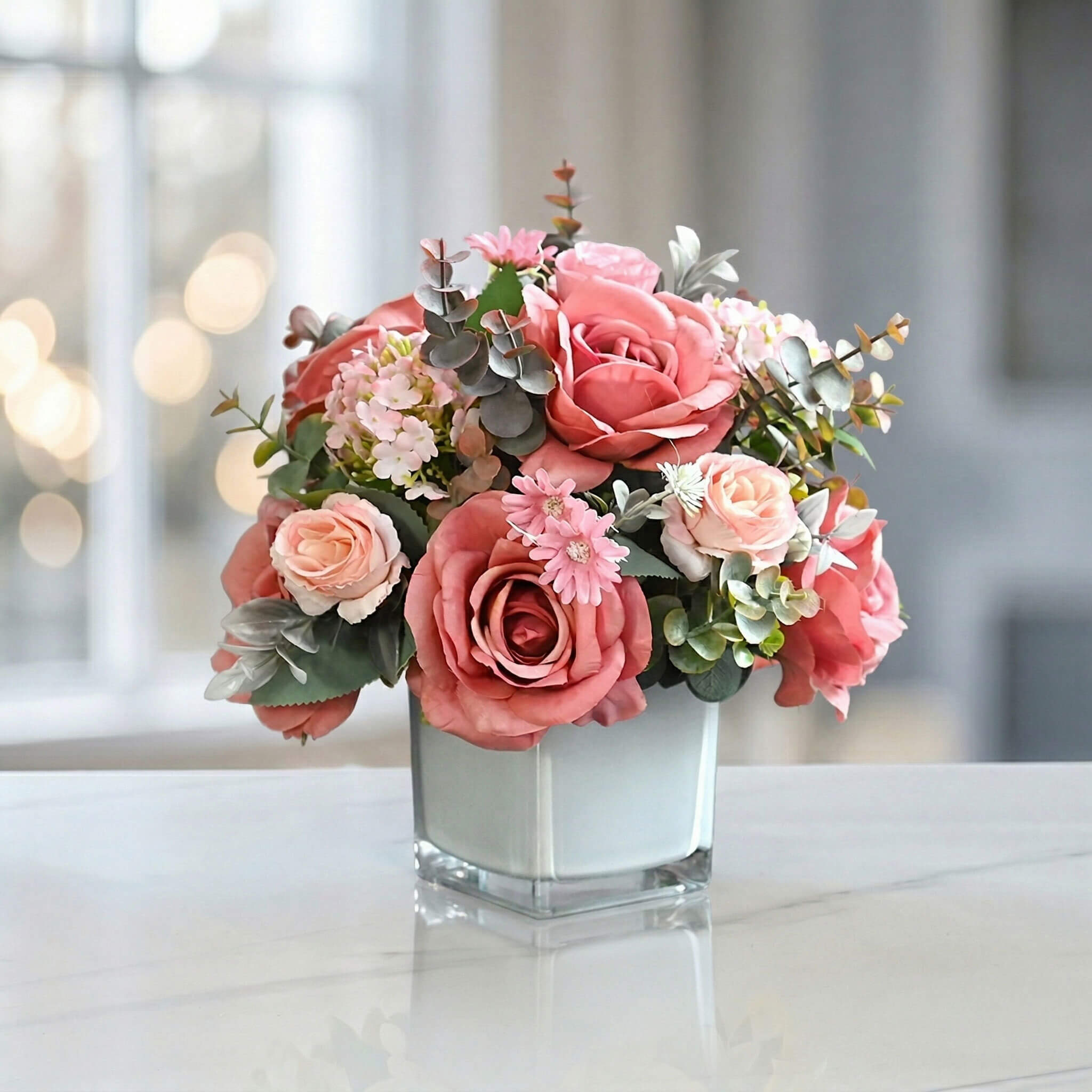Pink artificial rose and hydrangea flower arrangement with eucalyptus