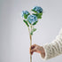 Single blue artificial hydrangea bloom showcasing lifelike color gradients and delicate petal structure.