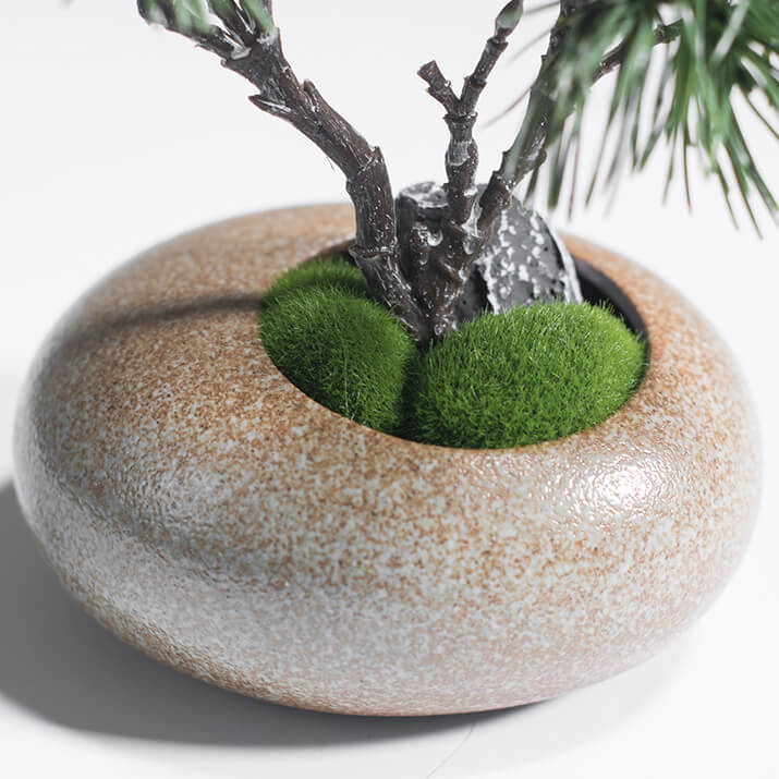 Ceramic vase with faux moss and stone base for artificial pine tree arrangement