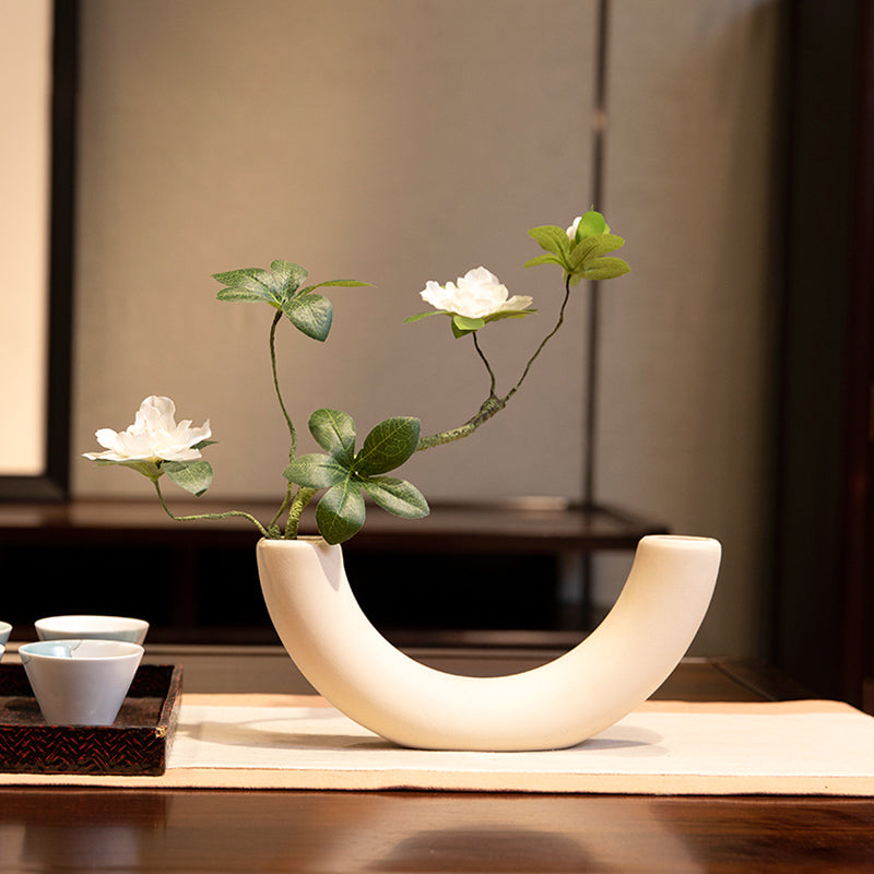 Silk azalea arrangement in a white semicircular vase, a compact and elegant accent for modern home decor.