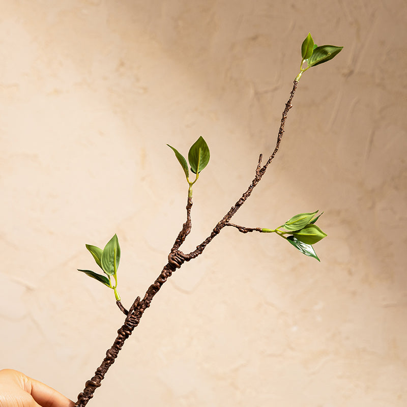 Front-facing view of faux ficus plant branch