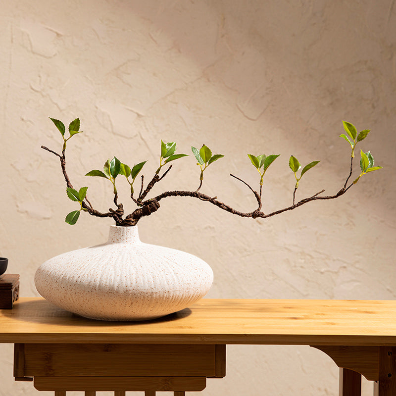 Faux ficus plant in white ceramic vase for calm home decor