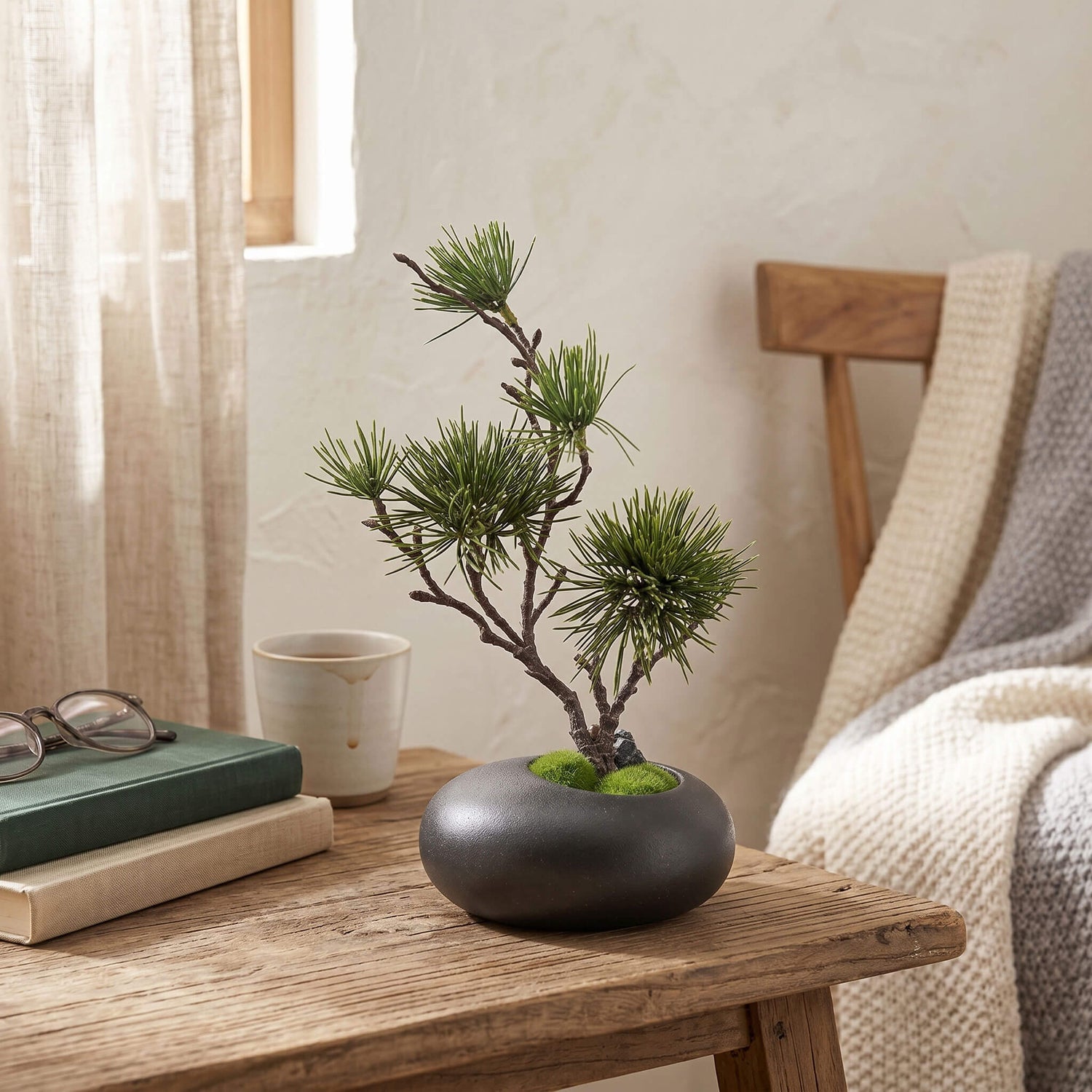 Artificial pine tree styled in a living room, placed on a coffee table for a clean and natural home accent.