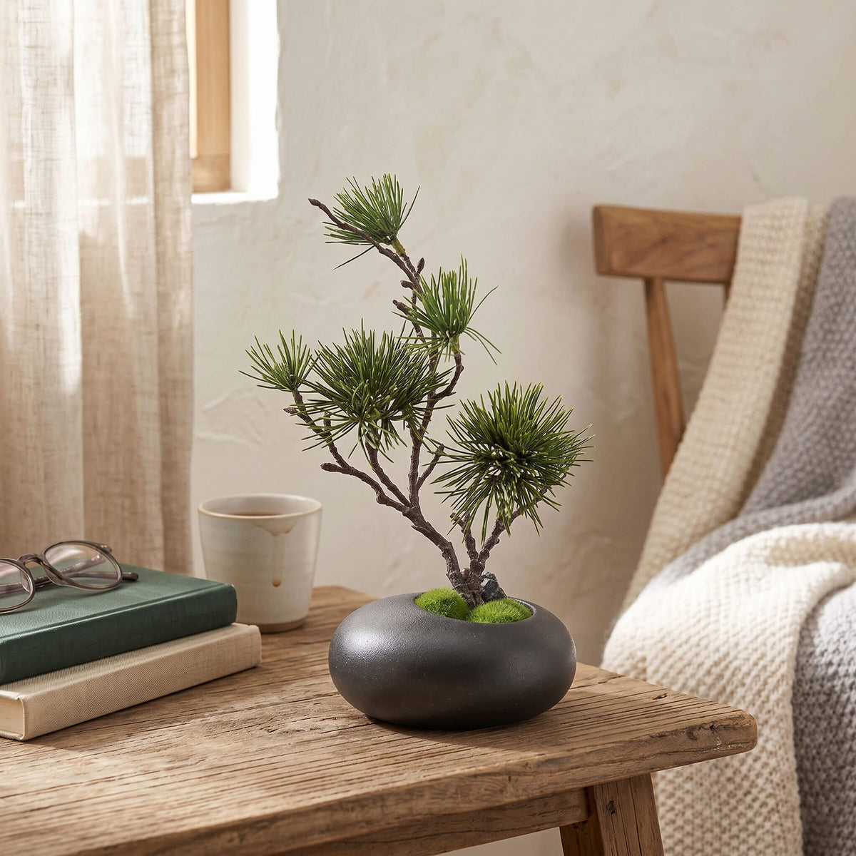Artificial pine tree styled in a living room, placed on a coffee table for a clean and natural home accent.
