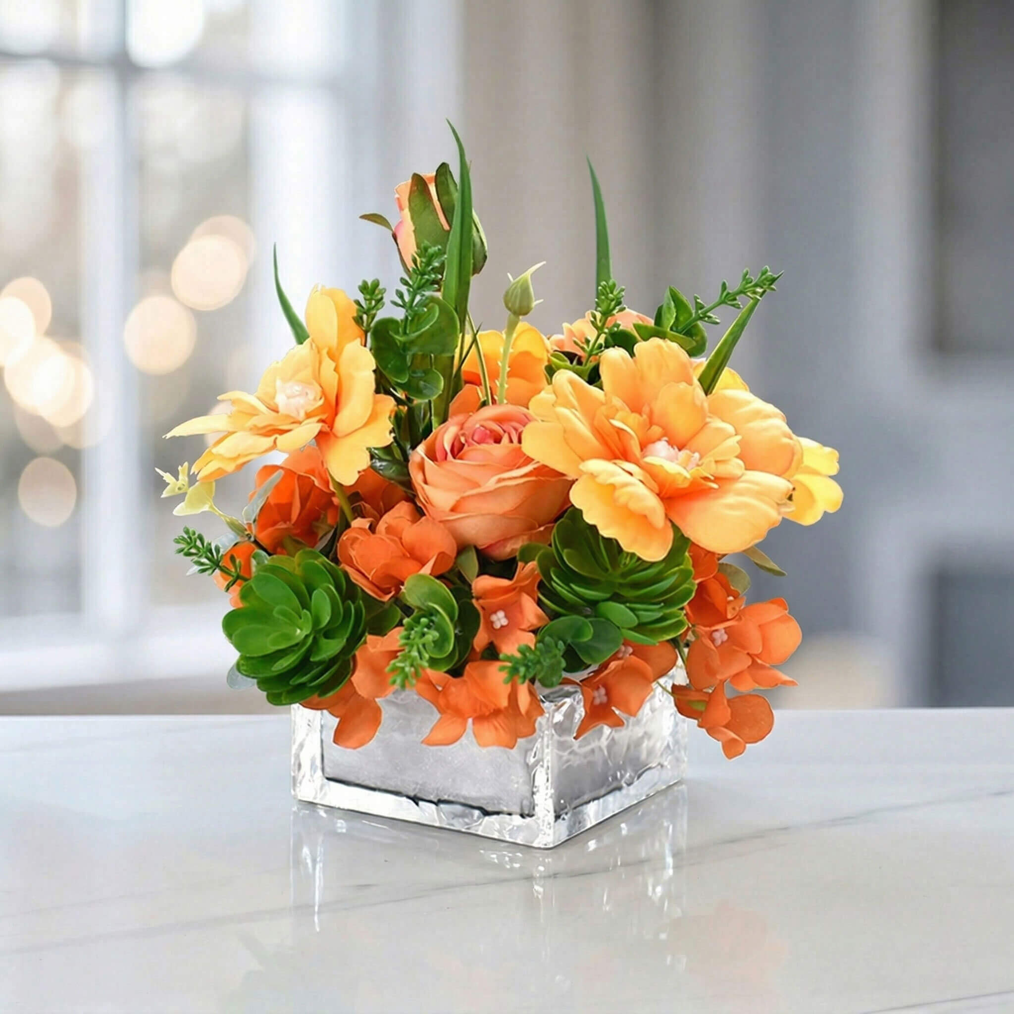 Orange artificial rose and hydrangea flower arrangement with succulent