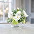 White faux rose and hydrangea floral centerpiece with succulent