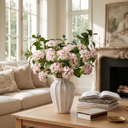 Pink hydrangea arrangement displayed on a living room coffee table, adding a fresh and welcoming focal point to the space.