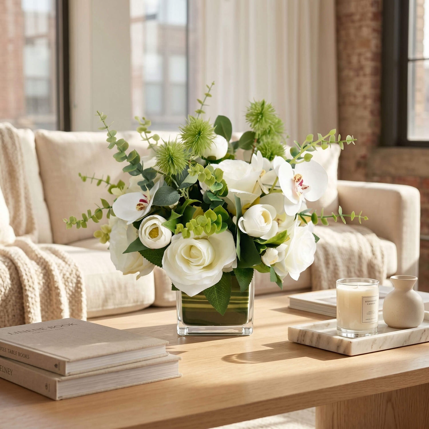 Orchid and rose floral centerpiece displayed on a living room coffee table, adding color, texture, and elegance to the seating area.