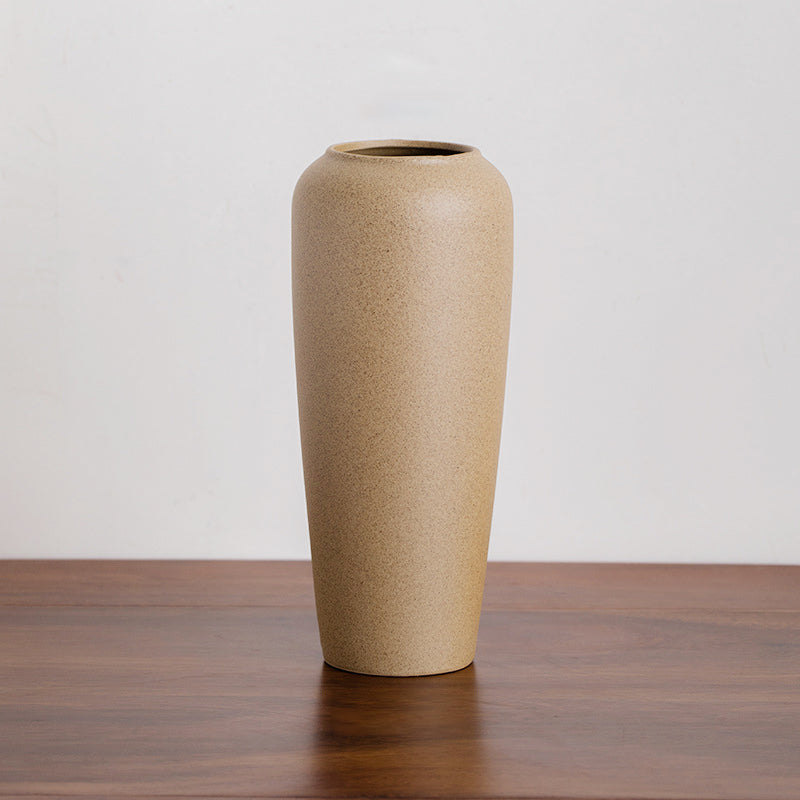 Tall pale yellow ceramic vase with a smooth minimalist design, ideal for elegant floral arrangements and home styling.