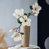 Real touch artificial magnolia arrangement in a pale yellow vase, elegant tall floral centerpiece for refined home decor.