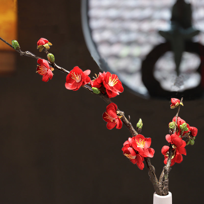 Front view of red artificial plum blossom, featuring vivid color and naturally shaped petals.