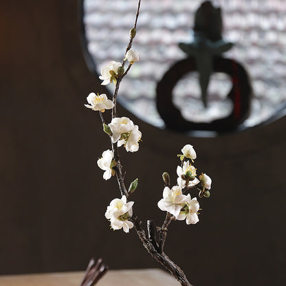 White artificial plum blossom in a front view, showcasing a clean look and subtle petal texture.